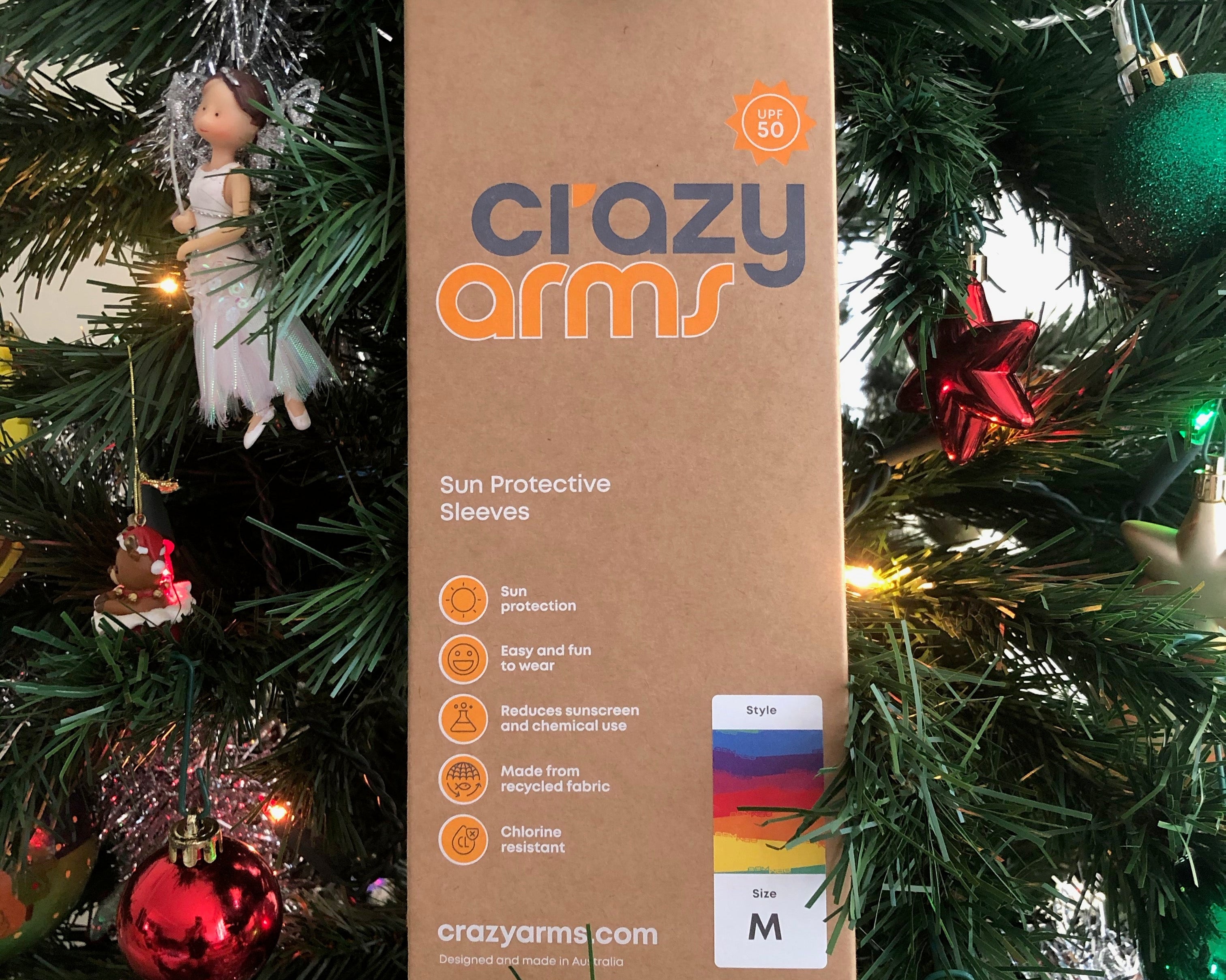 Crazy Arms sun sleeves box hanging in a Christmas tree