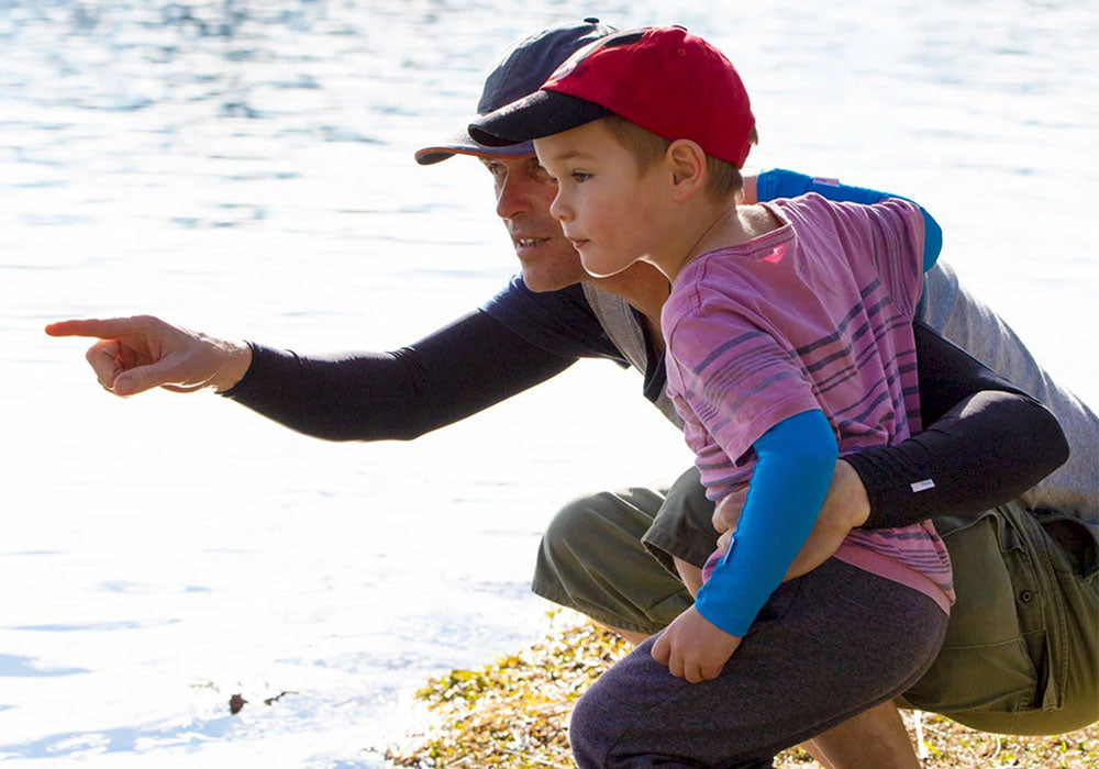 Father with child, pointing out wearing Crazy Arms sun sleeves