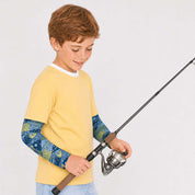 A young boy wearing a yellow short-sleeve t-shirt with blue fish-patterned sun sleeves,holding a fishing rod 