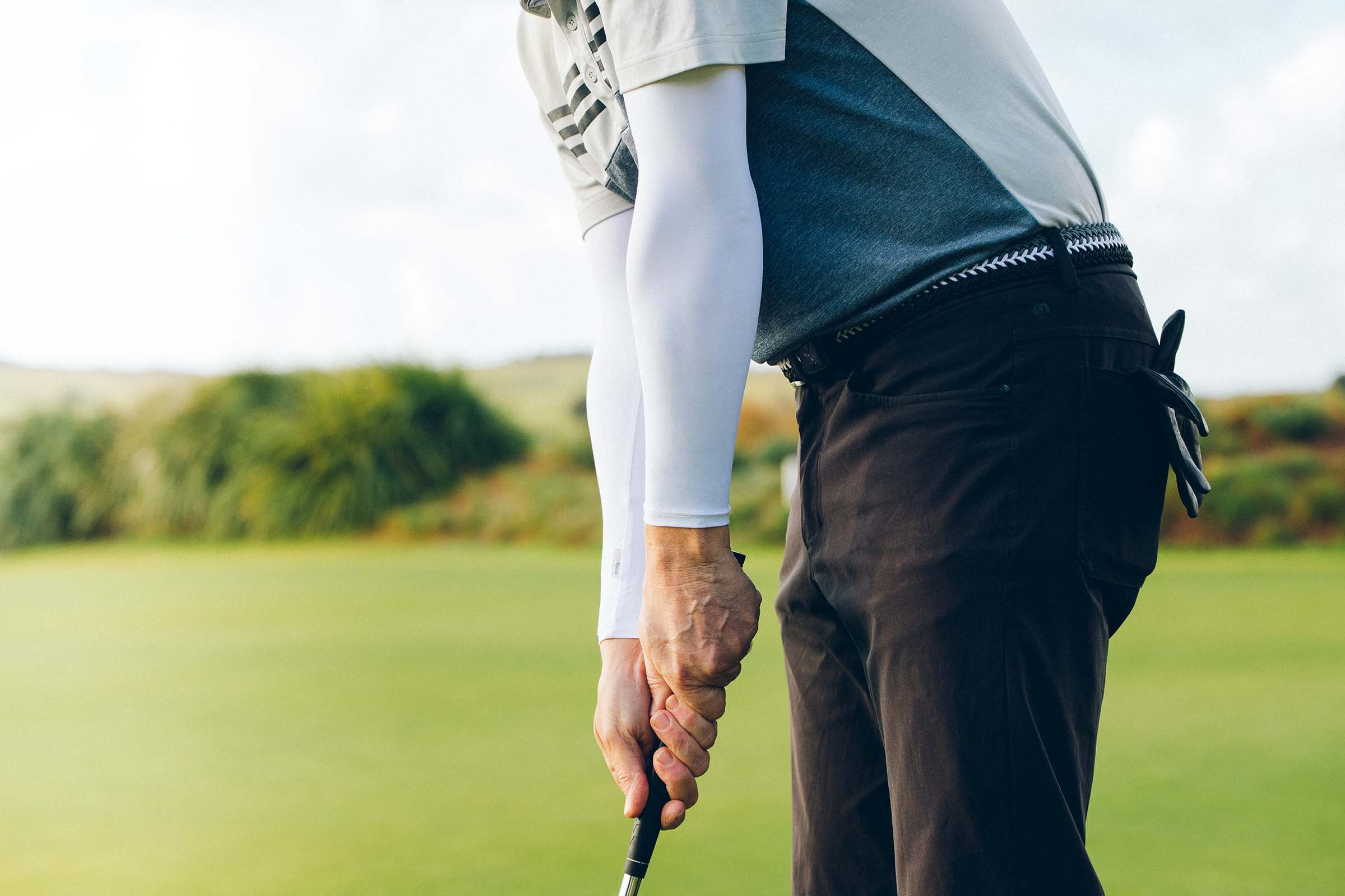 Crazy Arms White Golf Sleeves on golfer putting ball