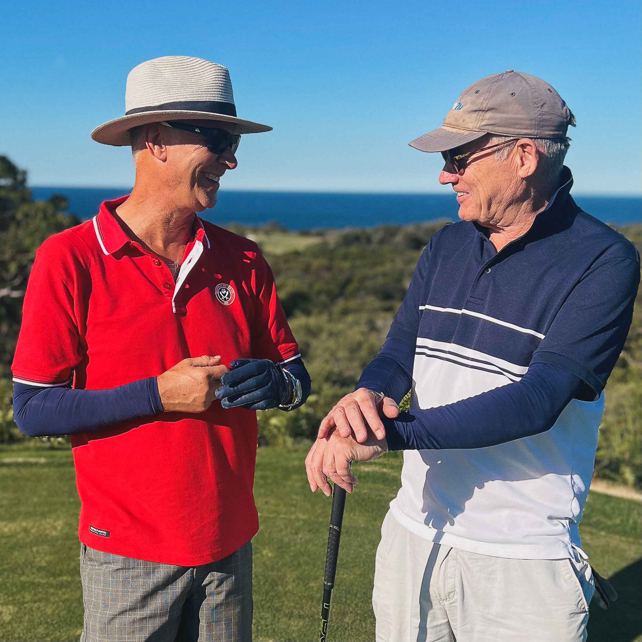 Golfer by a golf cart in patterned Crazy Arms sleeves